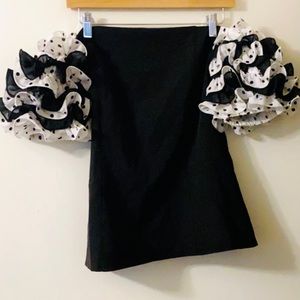New! Black shirt with black and white ruffle sleeves.